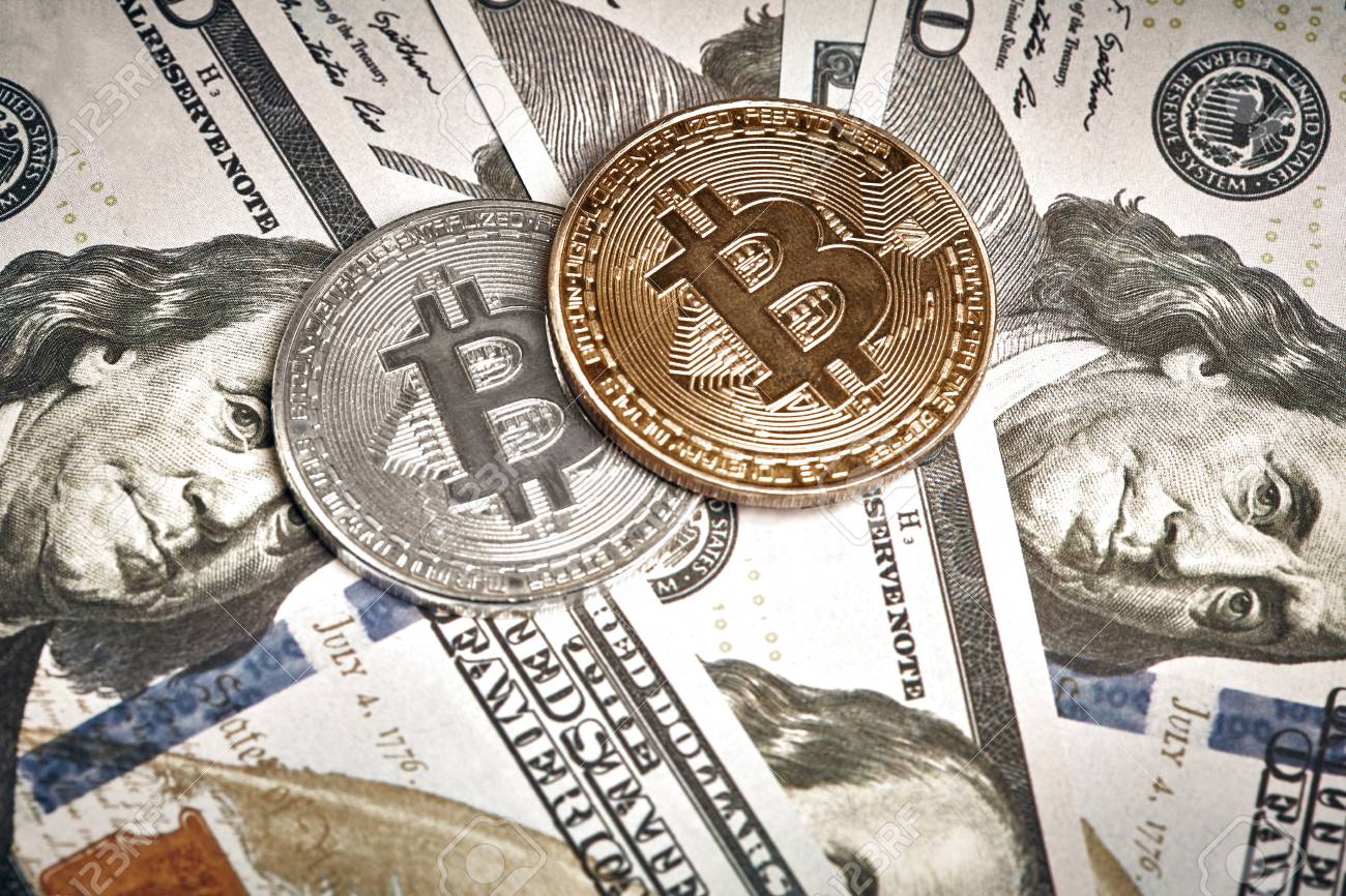 A Symbolic Coins Of Bitcoin On Banknotes Of One Hundred Dollars - 